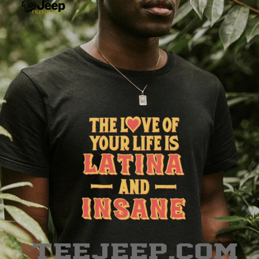 Person wearing 'Latina and Insane' shirt, smiling