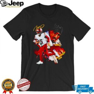 Washington Commanders football player running with the ball shirt