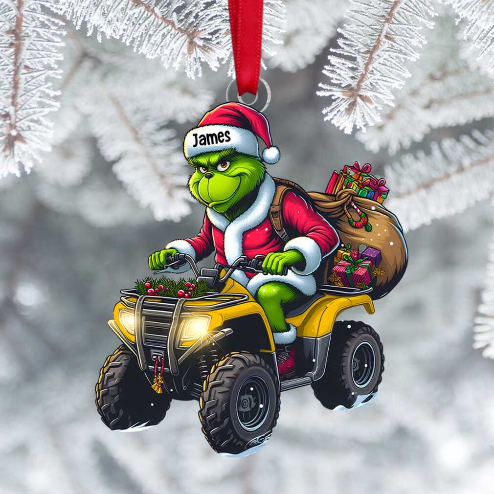 A festive James' Grinchmas Getaway Ornament featuring the Grinch with holiday and travel elements, hanging on a tree.